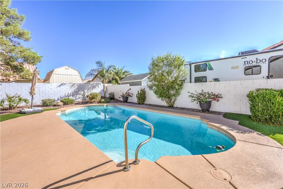 7504 Powder River Court, Las Vegas, NV 89131 An inviting swimming pool serves as the centerpiece of this enclosed backyard retreat.