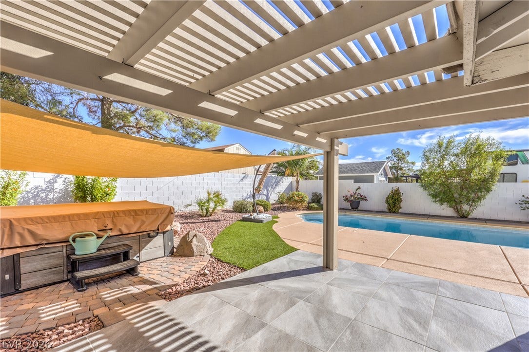 7504 Powder River Court, Las Vegas, NV 89131 An inviting backyard oasis features a tiled covered patio overlooking the pool and spa.