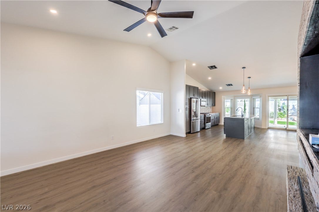7504 Powder River Court, Las Vegas, NV 89131 Vaulted ceilings and wood-look flooring enhance this inviting, open-concept living space.