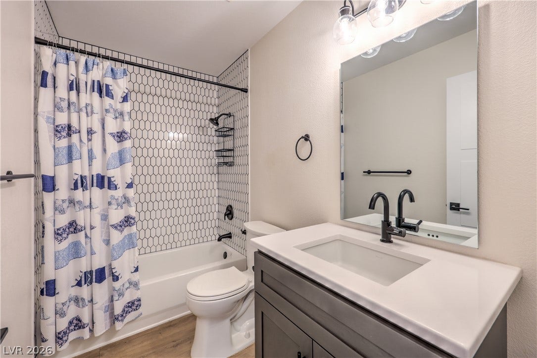 7504 Powder River Court, Las Vegas, NV 89131 Crisp geometric tile lines the shower surround in this modern bathroom.