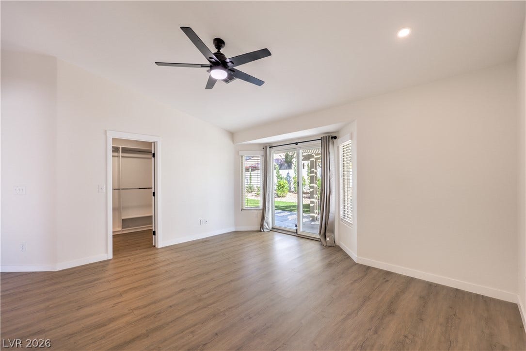 7504 Powder River Court, Las Vegas, NV 89131 Sliding glass doors open directly to the backyard from this airy bedroom.