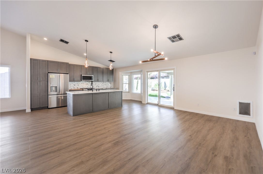 7504 Powder River Court, Las Vegas, NV 89131 Smooth wood-look flooring and a vaulted ceiling elevate this open-concept layout.