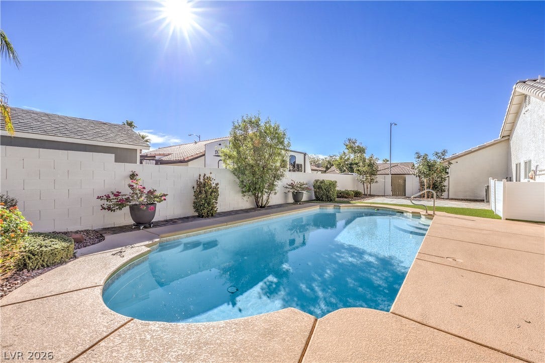 7504 Powder River Court, Las Vegas, NV 89131 A sparkling swimming pool anchors the sun-drenched backyard flanked by concrete decking.