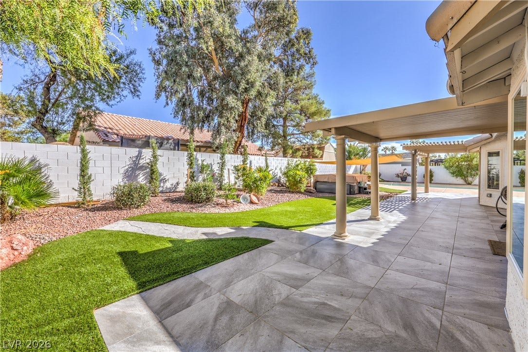 7504 Powder River Court, Las Vegas, NV 89131 A spacious covered patio leads directly to a neatly landscaped yard with artificial turf.