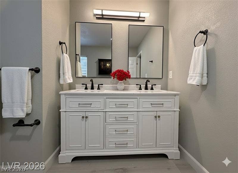 6489 Bugbee Avenue, Las Vegas, NV 89103 A stylish double vanity highlights this modern bathroom with clean architectural lines.