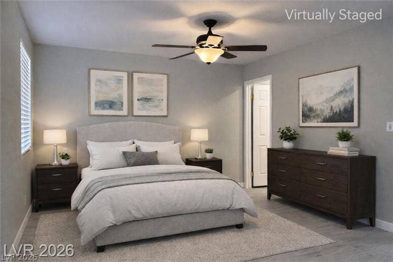 6489 Bugbee Avenue, Las Vegas, NV 89103 A tranquil atmosphere defines this bedroom featuring classic wood floors and large windows.