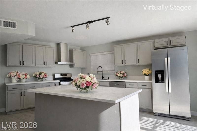 6489 Bugbee Avenue, Las Vegas, NV 89103 An expansive kitchen features stone countertops, modern cabinetry, and a central prep island.