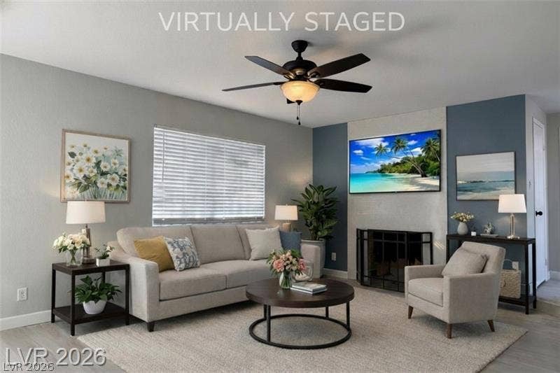 6489 Bugbee Avenue, Las Vegas, NV 89103 An inviting living space highlights a cozy fireplace and clean hard-surface flooring.