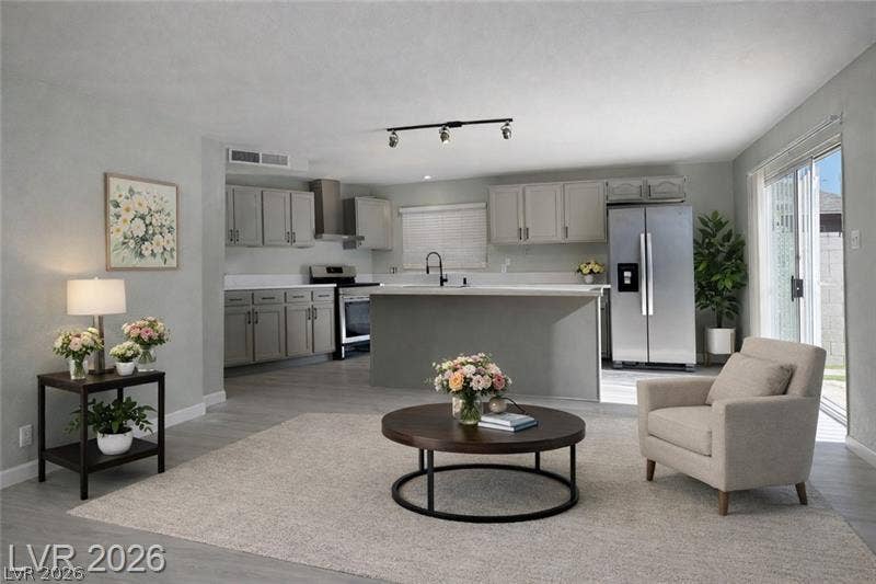 6489 Bugbee Avenue, Las Vegas, NV 89103 An open floor plan connects the comfortable living space directly to the kitchen area.