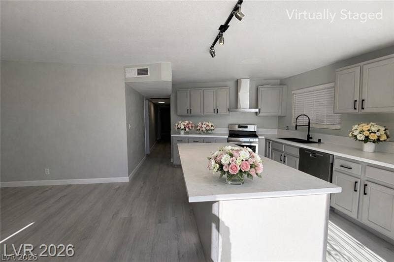 6489 Bugbee Avenue, Las Vegas, NV 89103 An open kitchen layout features a large central island and sleek solid surface countertops.