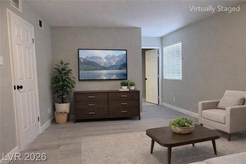 6489 Bugbee Avenue, Las Vegas, NV 89103 Smooth wood-look flooring and crisp white trim accent this versatile living space.