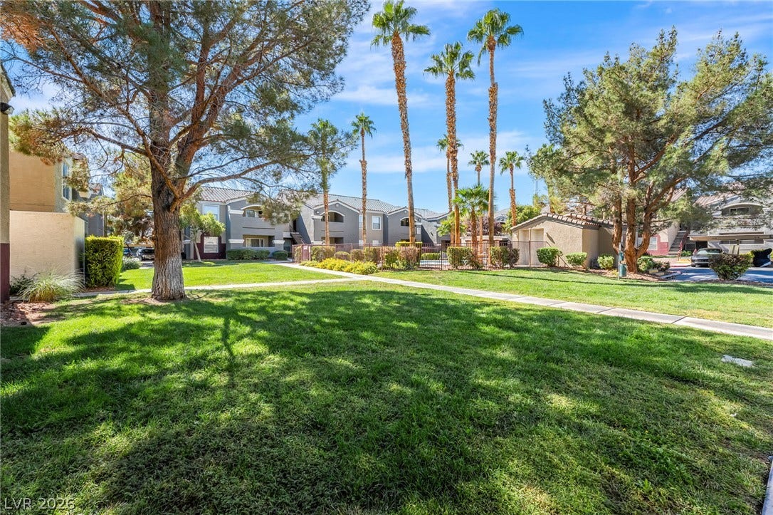 5055 W Hacienda Avenue, #1136, Las Vegas, NV 89118 Manicured green lawns and towering palm trees frame this inviting residential community setting.