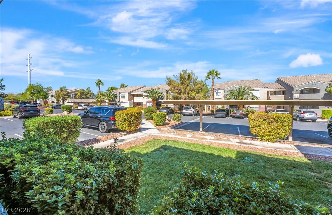 5055 W Hacienda Avenue, #1136, Las Vegas, NV 89118 Neat green lawns and mature landscaping frame the covered parking spaces outside this residential community.