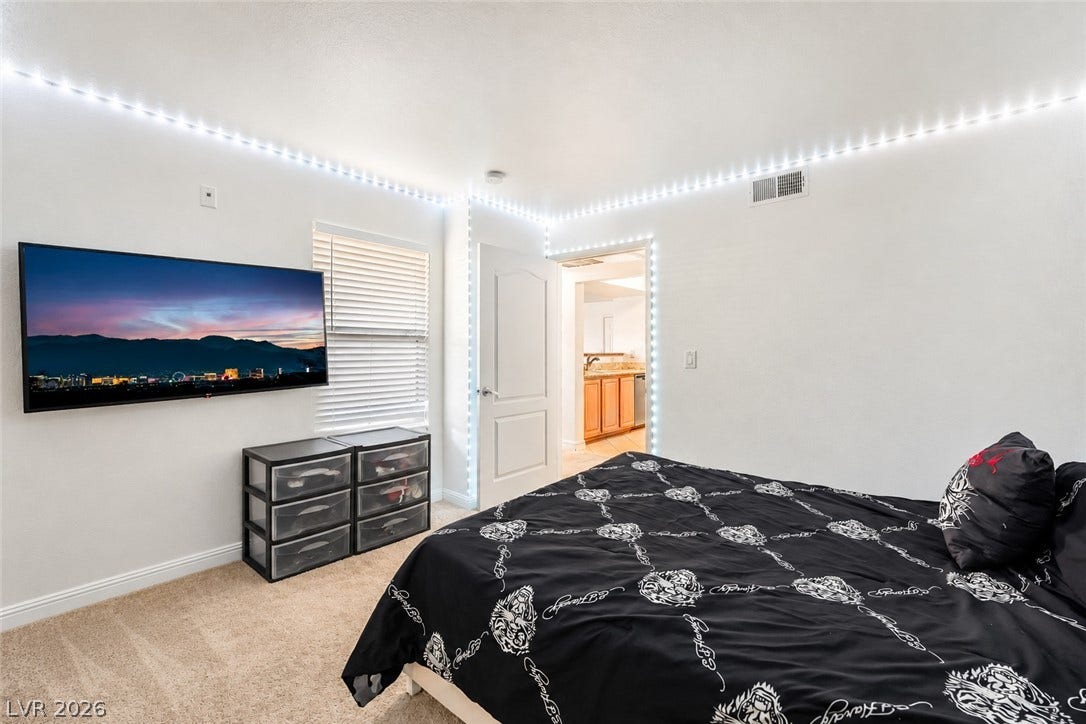 5055 W Hacienda Avenue, #1136, Las Vegas, NV 89118 Soft carpeting pairs with neutral walls in this comfortable secondary bedroom.