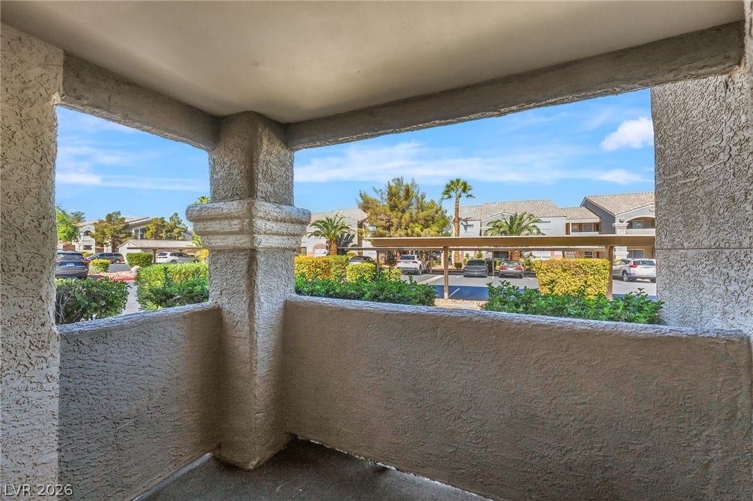 5055 W Hacienda Avenue, #1136, Las Vegas, NV 89118 A private covered balcony overlooks the surrounding neighborhood landscaping.