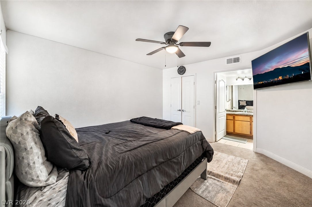 5055 W Hacienda Avenue, #1136, Las Vegas, NV 89118 Comfortable bedroom suite features soft carpeted floors and access to an adjoining bathroom.