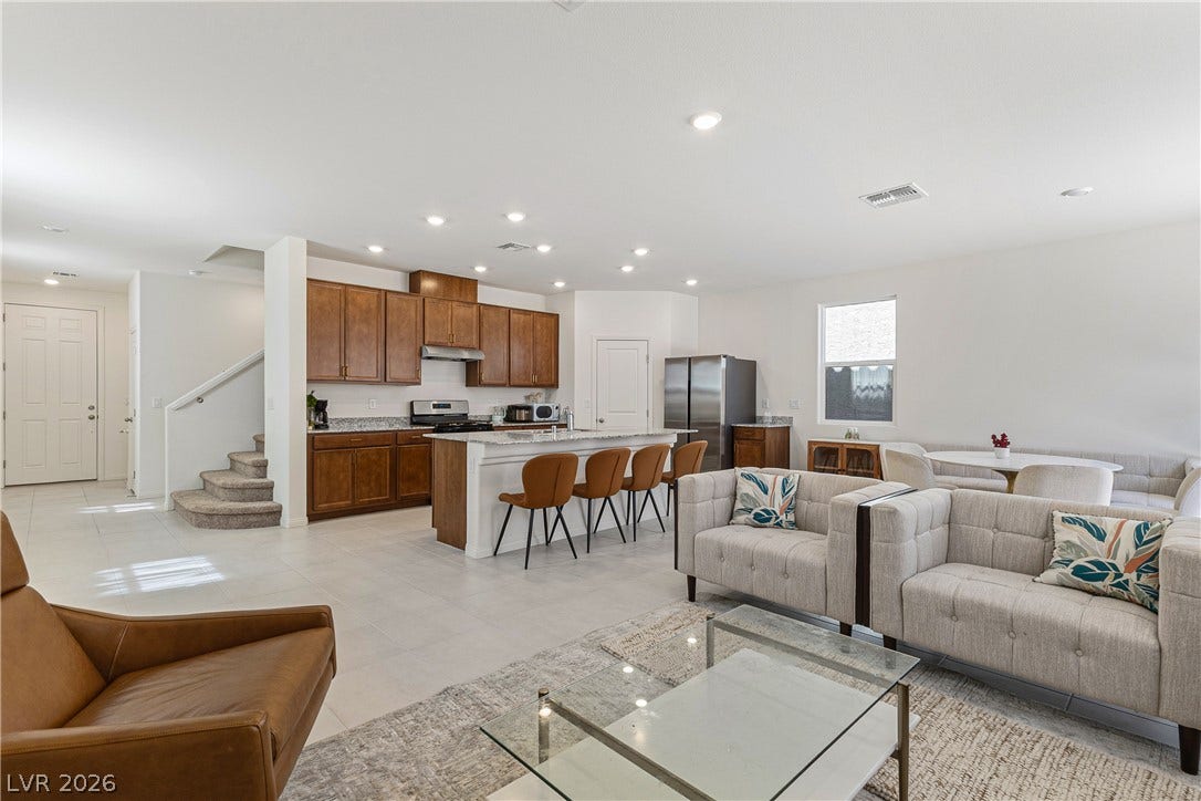 10034 Sir Atlas Court, Las Vegas, NV 89148 An open floorplan seamlessly connects the airy living area directly to the kitchen.