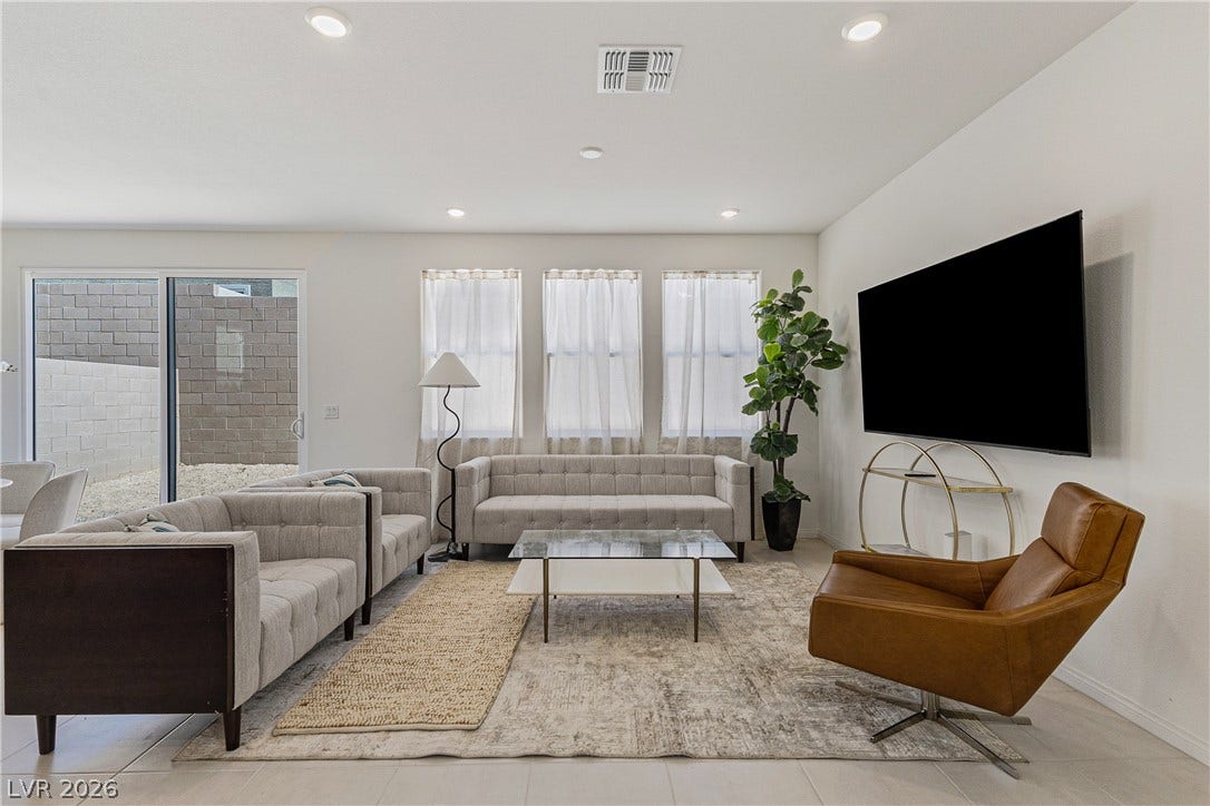 10034 Sir Atlas Court, Las Vegas, NV 89148 Recessed lighting and a sliding glass door illuminate this spacious main living area.