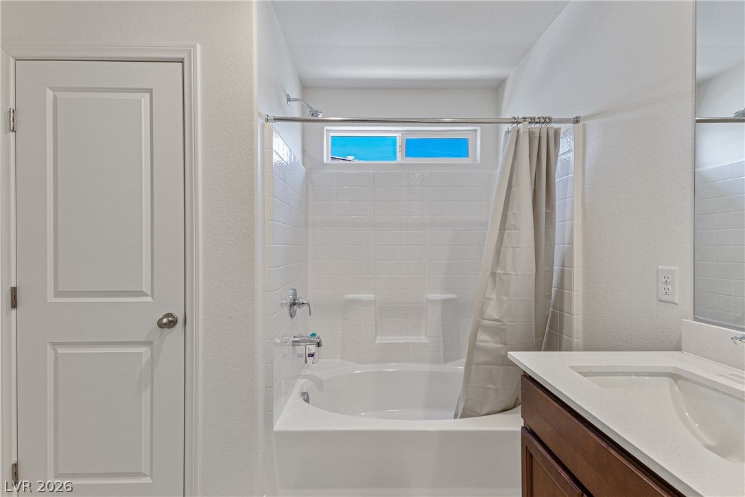 10034 Sir Atlas Court, Las Vegas, NV 89148 Clean lines and classic tile surround this tub and shower combination.