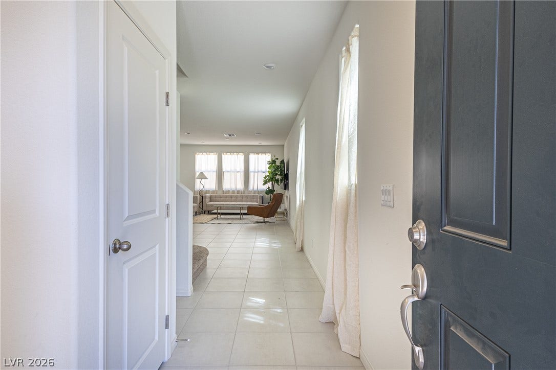 10034 Sir Atlas Court, Las Vegas, NV 89148 An inviting entrance hallway features tiled flooring and leads directly into the open living spaces.