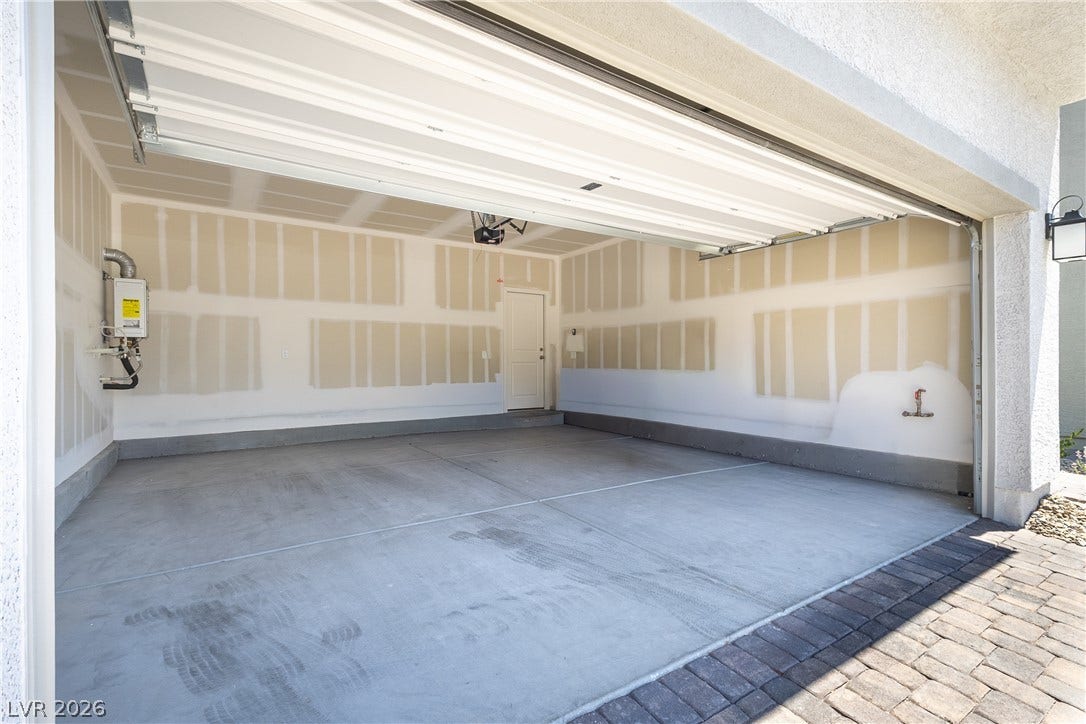 10034 Sir Atlas Court, Las Vegas, NV 89148 A spacious garage includes unfinished drywall and a solid concrete foundation.