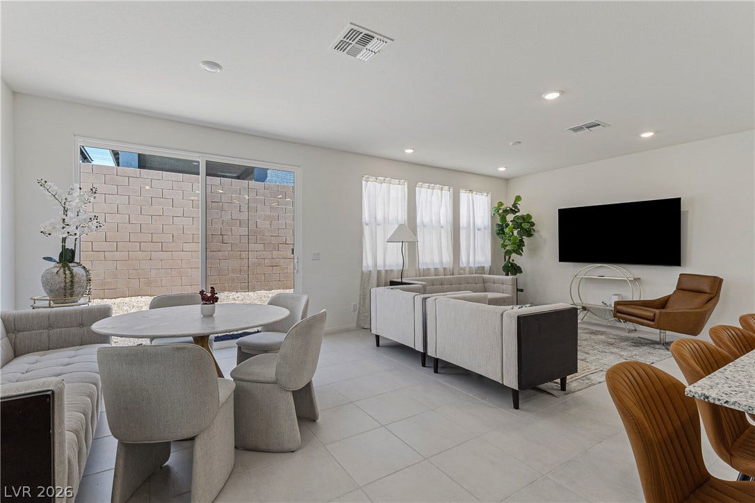 10034 Sir Atlas Court, Las Vegas, NV 89148 Gleaming tile floors and sliding glass doors define this open, light-filled living and dining layout.