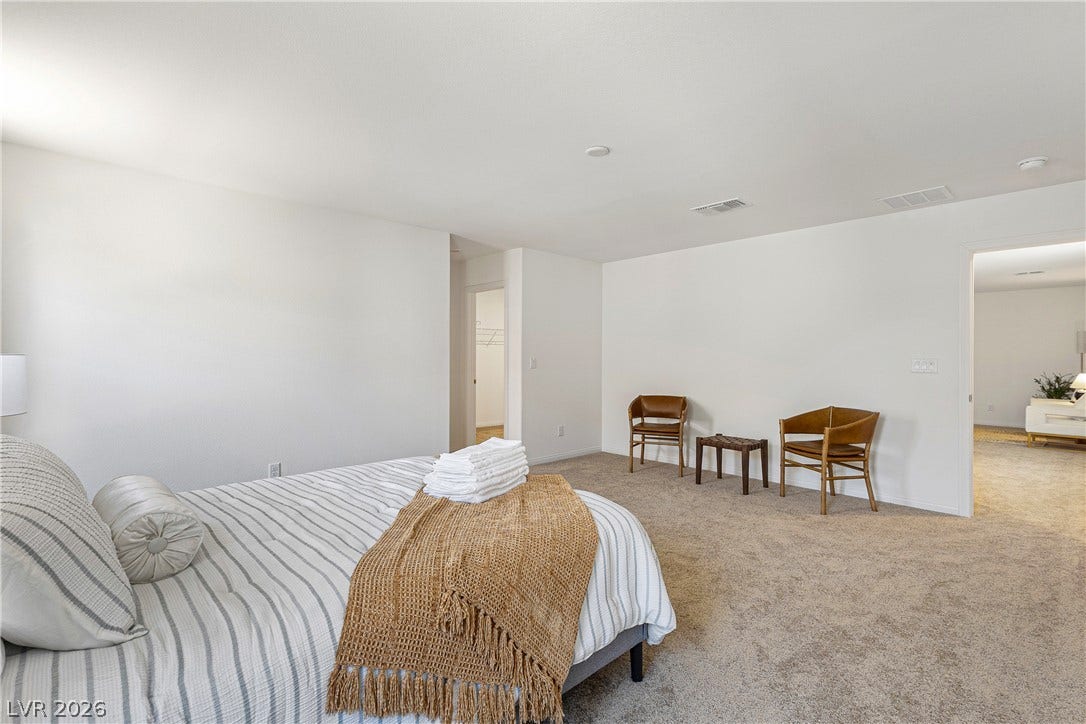 10034 Sir Atlas Court, Las Vegas, NV 89148 An open and spacious bedroom features neutral wall tones and soft wall-to-wall carpeting.