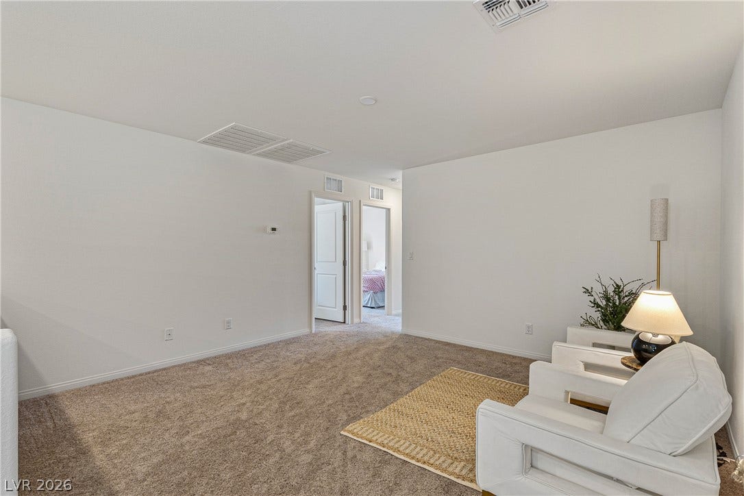 10034 Sir Atlas Court, Las Vegas, NV 89148 Plush wall-to-wall carpeting and clean white walls define this versatile upstairs loft space.