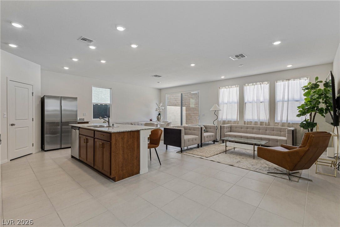 10034 Sir Atlas Court, Las Vegas, NV 89148 An open layout connects the kitchen and living areas over uniform tile flooring.