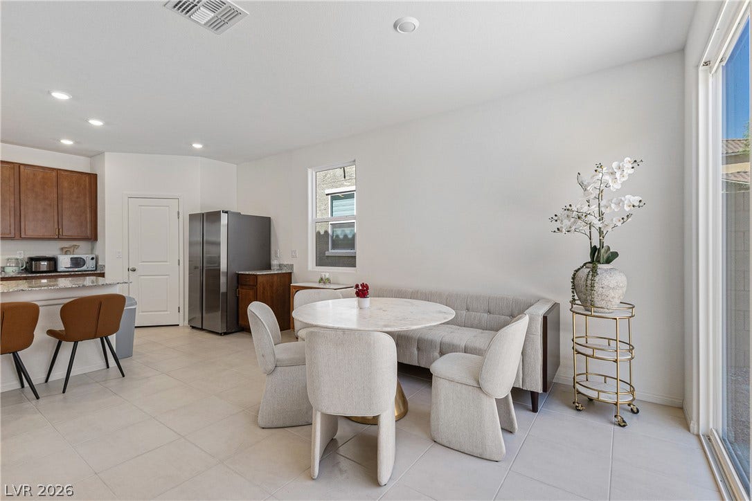 10034 Sir Atlas Court, Las Vegas, NV 89148 An open dining area flows into the kitchen over uniform tile floors.