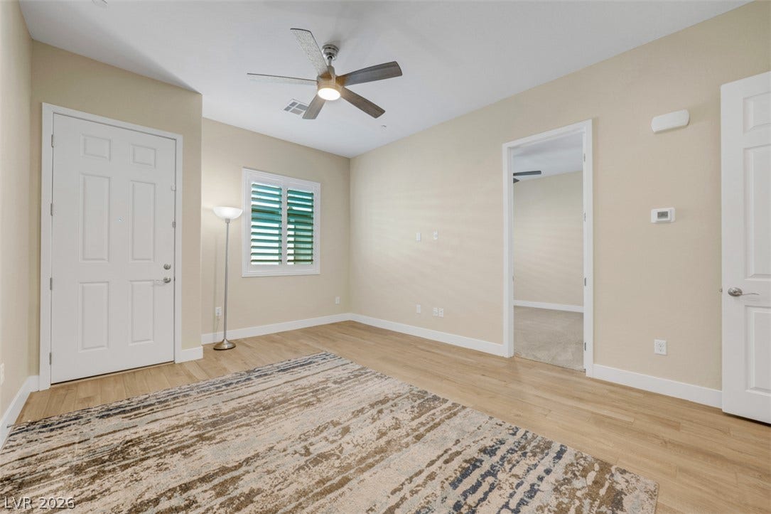 Smooth wood floors and crisp white trim enhance this versatile neutral living space.