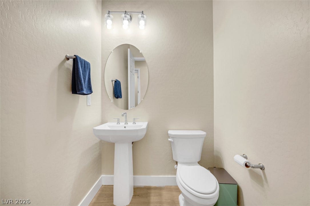 Smooth walls and classic fixtures define this neat powder room.