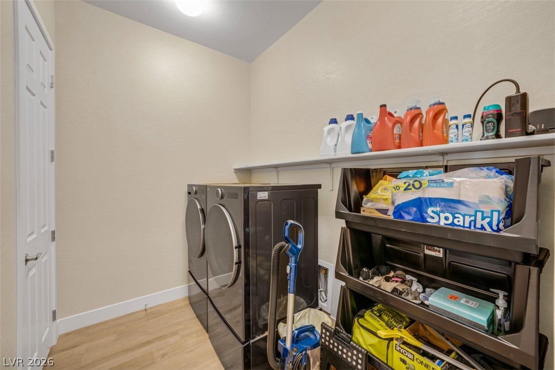 Hardwood floors and built-in shelving maximize organization in this dedicated utility space.