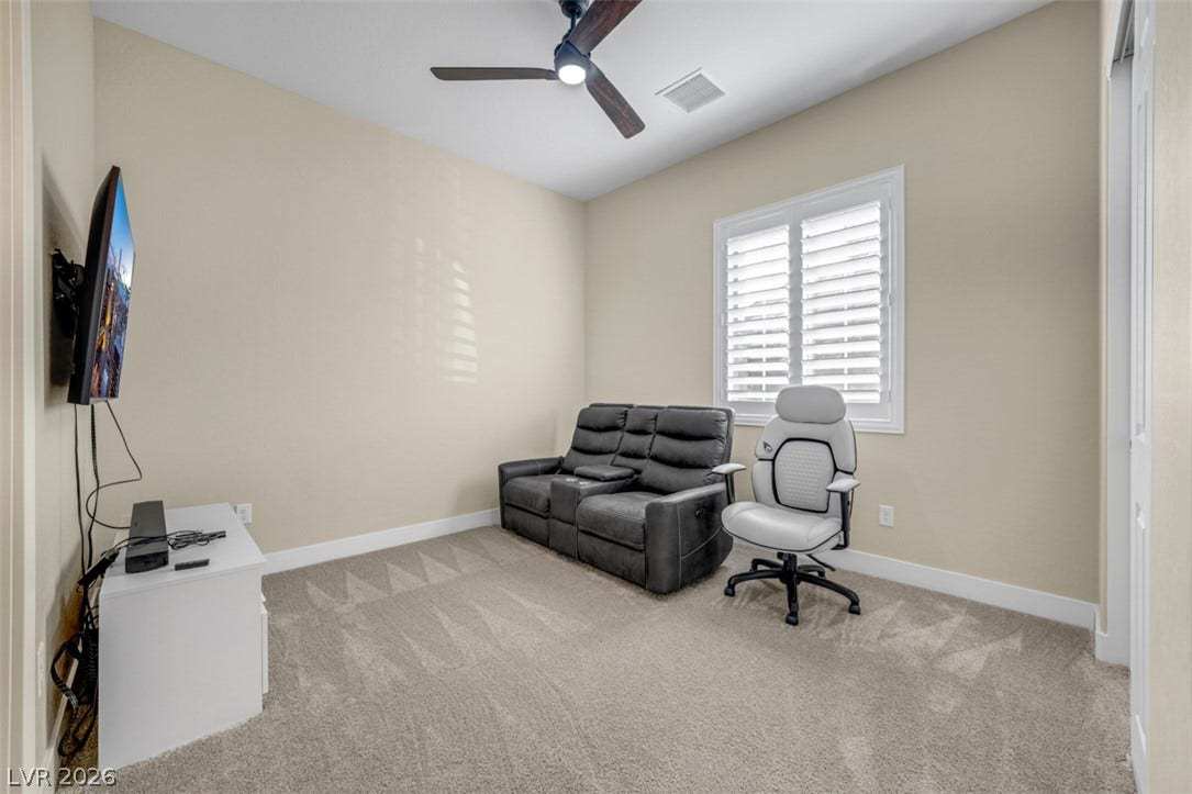Plush carpeting and plantation shutters define this versatile secondary room.