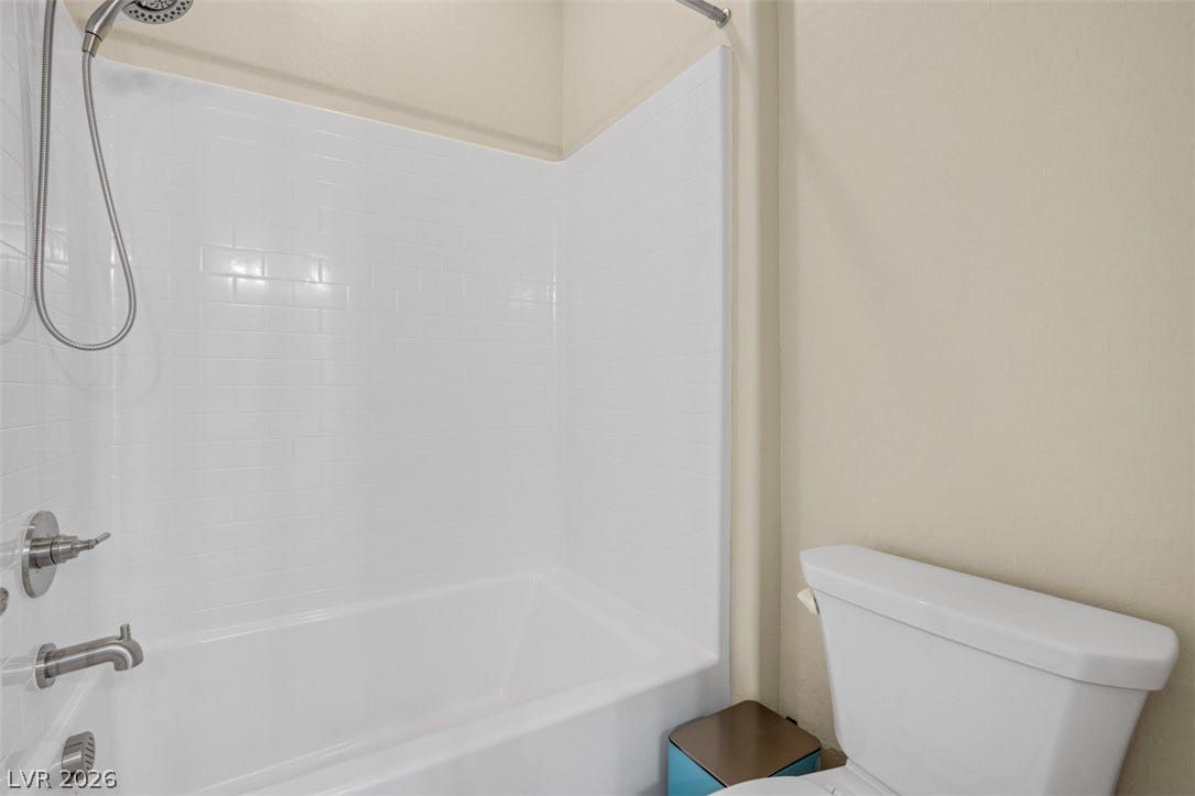 Clean lines and a classic tile tub surround define this updated bathroom space.