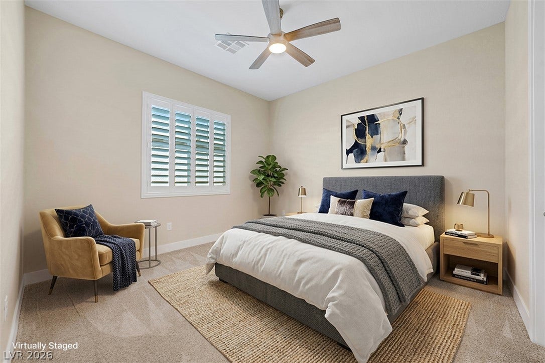 Crisp plantation shutters and soft carpeting define this comfortable and inviting bedroom retreat.