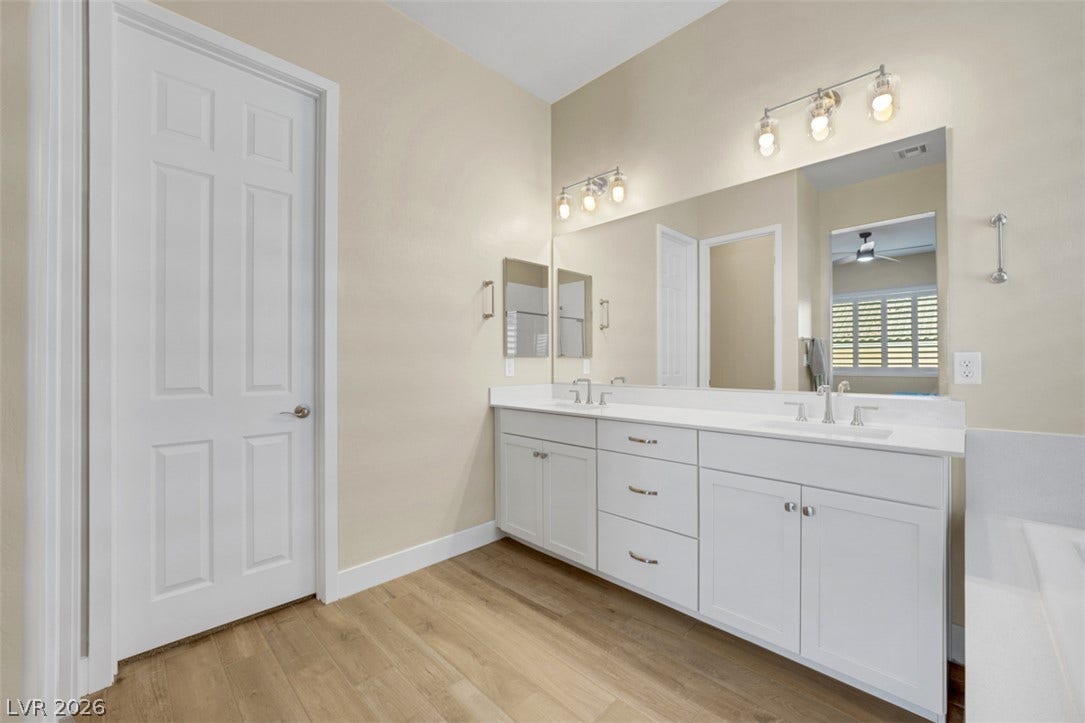 Clean lines and a spacious dual vanity define this updated bathroom layout.