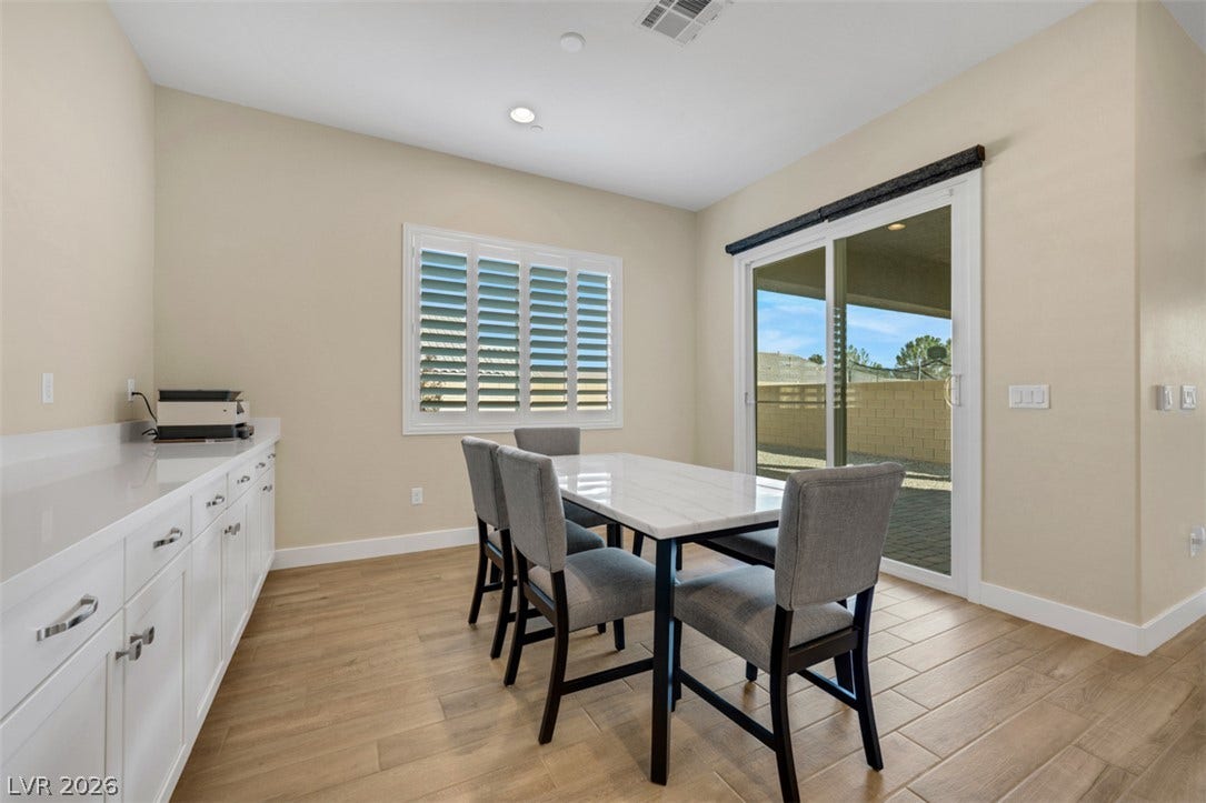 Sliding glass doors open from the dining space directly to the backyard patio.