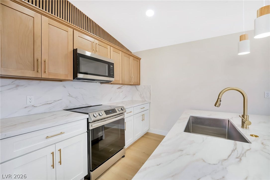 Elegant stone countertops and modern cabinetry define this sleek culinary space.