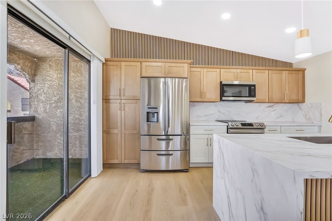 Soaring vaulted ceilings and warm wood tones define this modern culinary workspace.