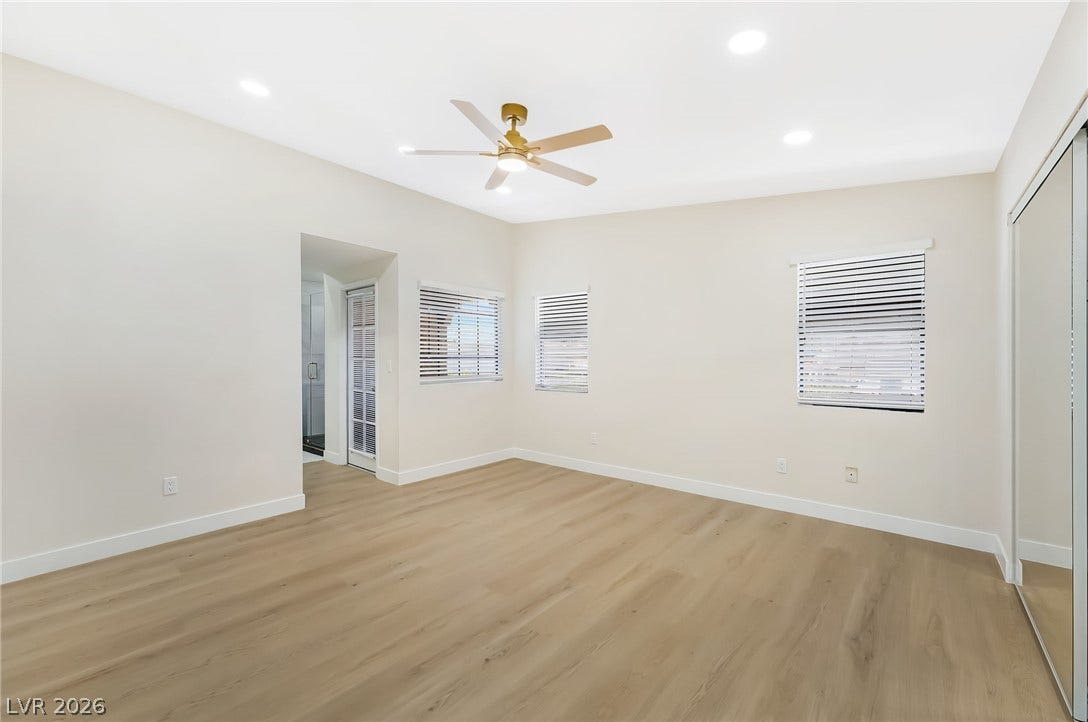 Recessed lighting and warm wood flooring define this versatile, open living space.