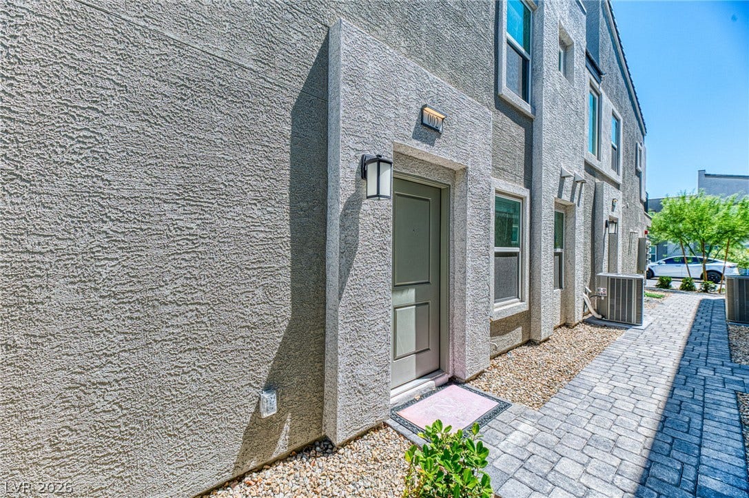 264 Banished Avenue, #2, North Las Vegas, NV 89031 A welcoming entry invites you home with a textured exterior and paver pathway.