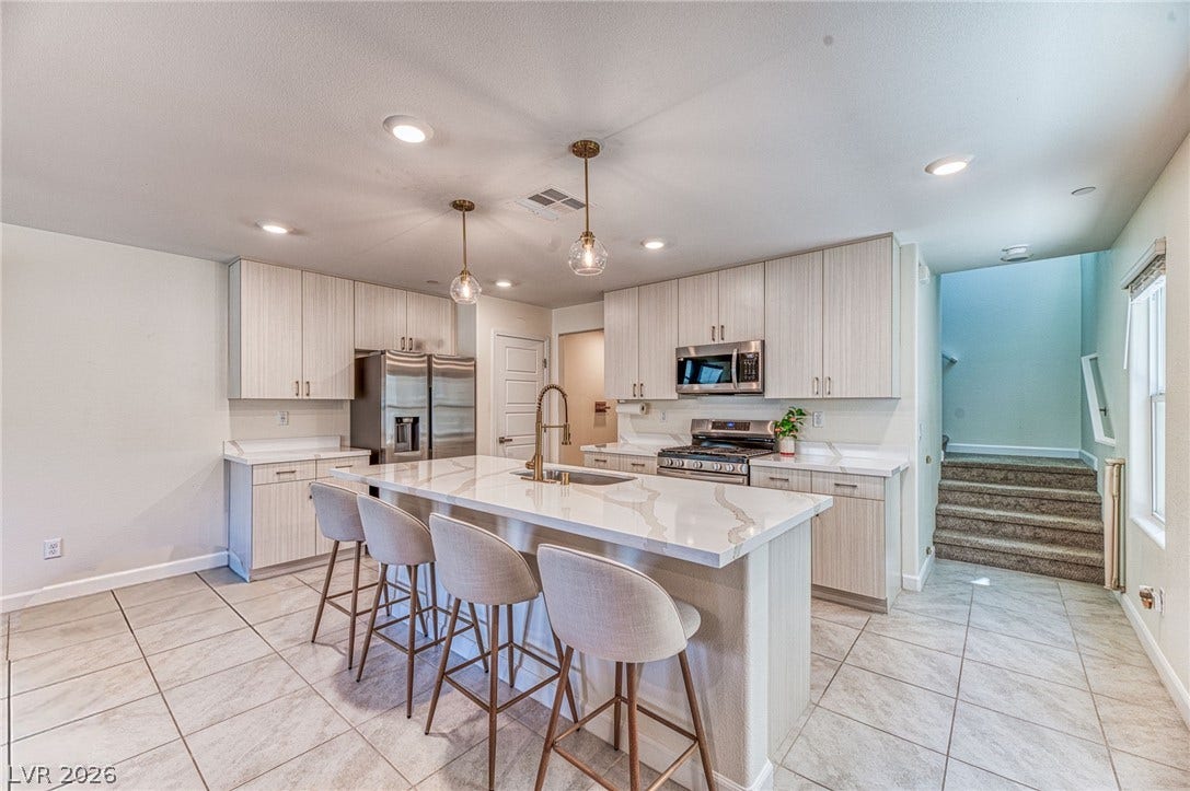 264 Banished Avenue, #2, North Las Vegas, NV 89031 Culinary delights await in this modern kitchen with an inviting island, stainless steel appliances, and sleek finishes.
