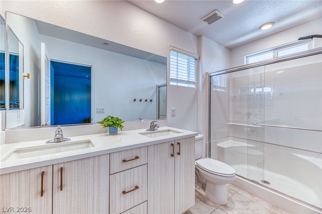 264 Banished Avenue, #2, North Las Vegas, NV 89031 A well-appointed bathroom features a spacious shower and a dual-sink vanity with ample counter space.