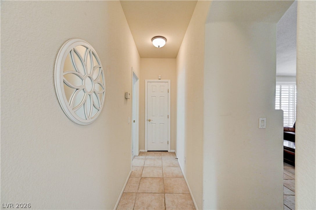Smooth tiled flooring runs through this central corridor leading deeper into the home.