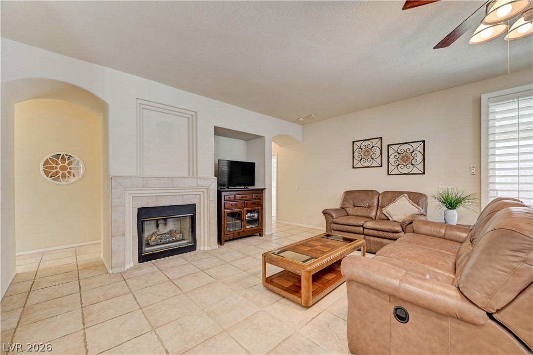 Tiled flooring and a classic fireplace anchor this inviting living space.