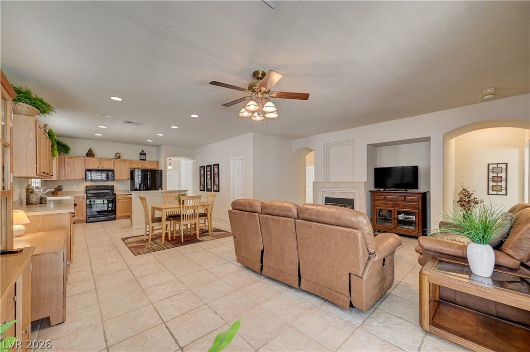 A spacious open-plan layout connects the main living areas seamlessly over tiled flooring.