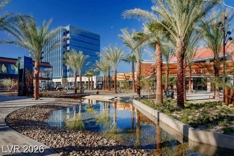 DOWNTOWN SUMMERLIN  Lush palm trees and modern architectural lines frame a serene reflecting pool.