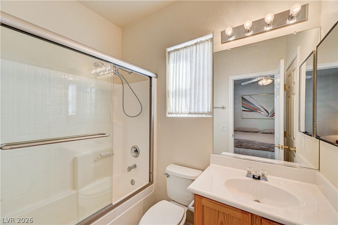 CASITABA BATHROOM classic vanity stands adjacent to a tub and shower combination enclosed by glass doors.