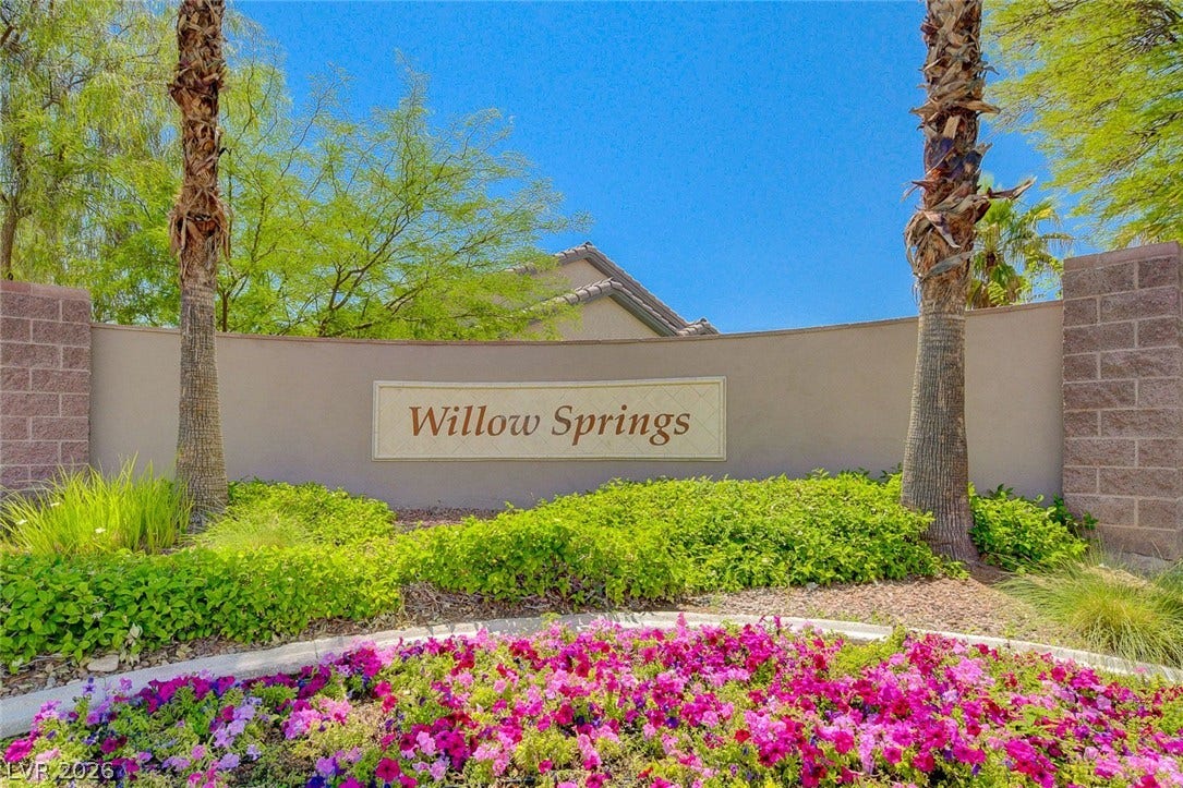 Lush landscaping and stone accents frame the welcoming entrance sign to this desirable community.